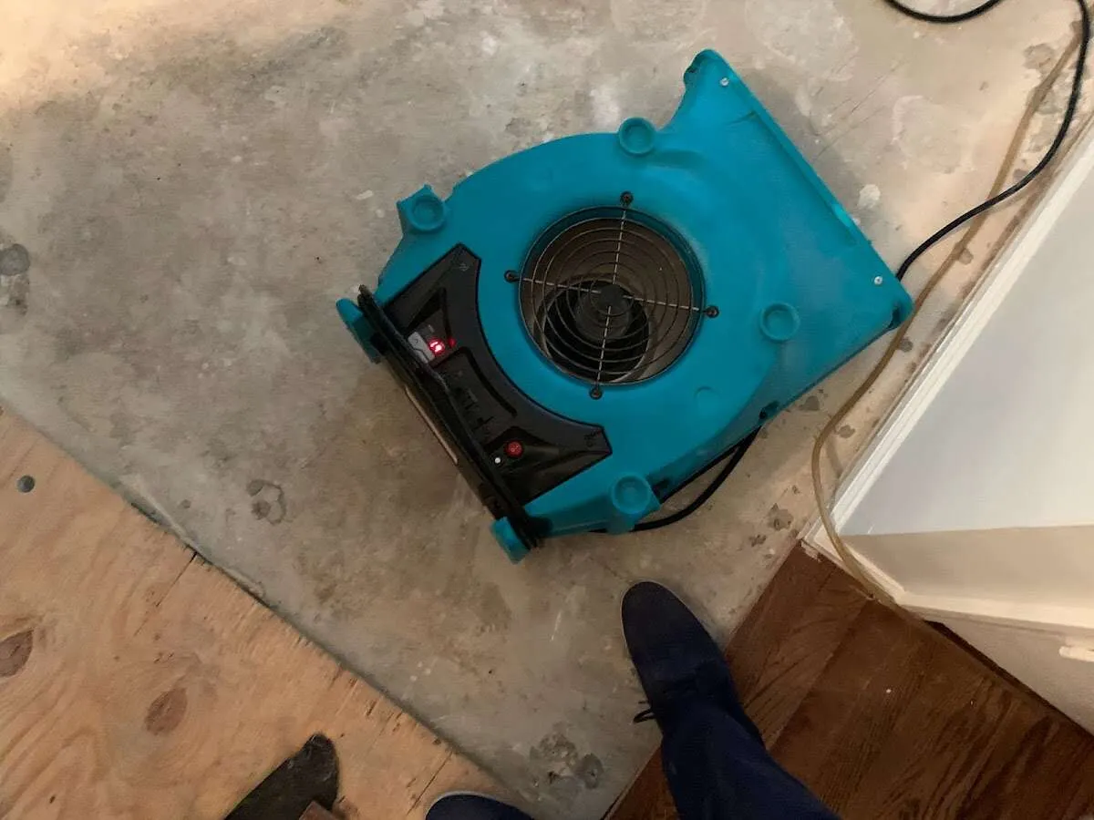 Air mover drying subfloor during Commercial Water Damage Restoration in Caldwell